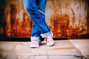 student standing in pink tennis shoes
