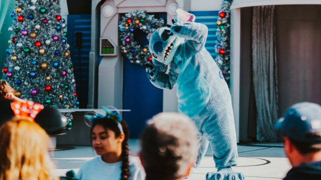 Student in mascot costume performing onstage due to the help of Educational Discovery Tours.