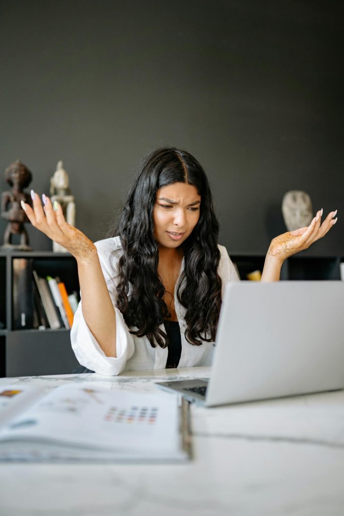 Frustrated mother on computer in need of educational travel company